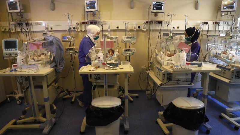 Nurses work at the neonatal intensive care unit, at Family Medical Center, a private hospital facing financial difficulties, in Majdalaiya village, north Lebanon, Thursday, July 16, 2020. Just as Lebanon faces a surge in coronavirus cases, hospitals are cracking under the country's financial crisis. They are struggling to pay staff, keep equipment running or even stay open amid shortages in key supplies like anesthesia and sutures. The health sector has long been one of the best in the Middle East, with its private hospitals drawing patients from around the region. But with dollars in short supply and the state unable to pay insurance bills, hospitals are having to turn away patients and close wards to cut costs. Public facilities, on the front line of the coronavirus fight, are too underfunded and understaffed to fill the gap. (AP Photo/Hussein Malla)