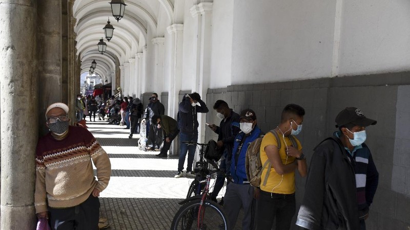 Bolivians line up outside a pharmacy in Cochabamba, Bolivia, Friday, July 17, 2020. Long lines form every morning in  Cochabamba, one of the Bolivian cities hardest hit by the new coronavirus pandemic as people wait to buy small bottles of chlorine dioxide, a toxic bleaching agent that has been falsely touted as a cure for COVID-19 and myriad other diseases. (AP Photo/Dico Solis)