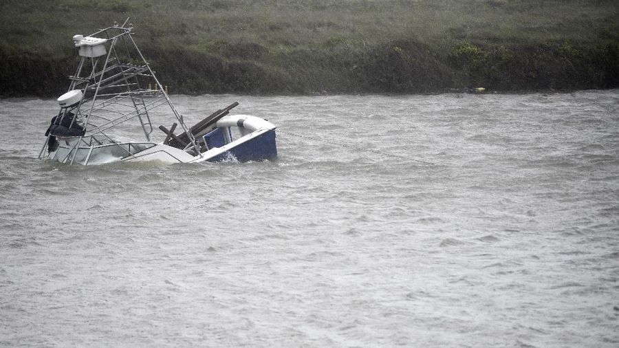 A boat sinks in the Packery Channel during Hurricane Hanna, Saturday, July 25, 2020, in North Padre Island, Texas. The Category 1 storm continued to strengthen before reaching Padre Island at 5 p.m. Saturday. (Annie Rice/Corpus Christi Caller-Times via AP)