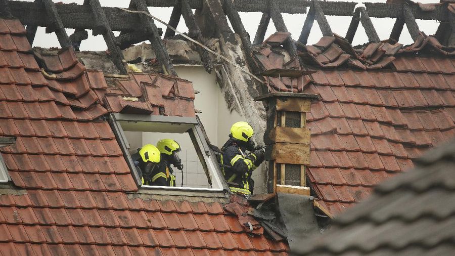 Emergency services attend the scene after a light plane crashed into an apartment building in Wesel, Germany, Saturday July 25, 2020. Three people died on Saturday after an ultra-light aircraft crashed into the apartment building and caught fire.(David Young/dpa via AP)