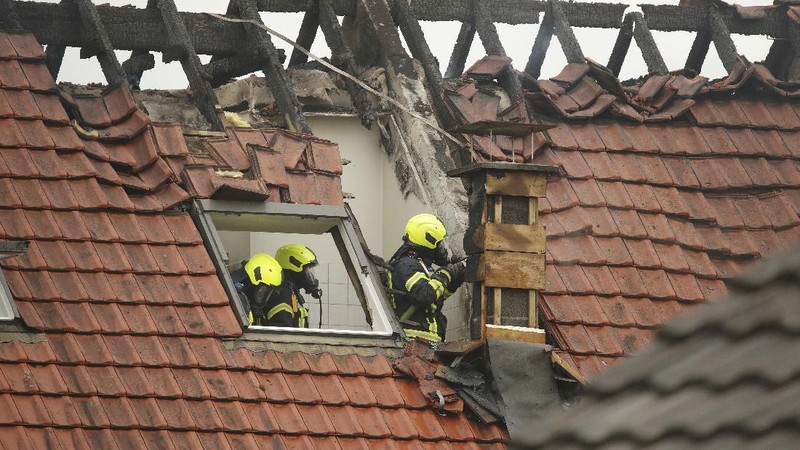 Emergency services attend the scene after a light plane crashed into an apartment building in Wesel, Germany, Saturday July 25, 2020. Three people died on Saturday after an ultra-light aircraft crashed into the apartment building and caught fire.(David Young/dpa via AP)