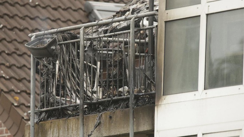 Emergency services attend the scene after a light plane crashed into an apartment building in Wesel, Germany, Saturday July 25, 2020. Three people died on Saturday after an ultra-light aircraft crashed into the apartment building and caught fire.(David Young/dpa via AP)