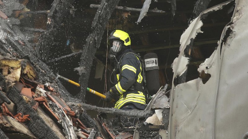 Emergency services attend the scene after a light plane crashed into an apartment building in Wesel, Germany, Saturday July 25, 2020. Three people died on Saturday after an ultra-light aircraft crashed into the apartment building and caught fire.(David Young/dpa via AP)