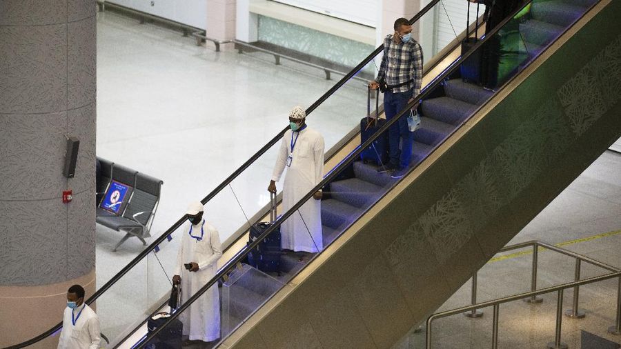 Pilgrims arrive to King Abdulaziz Airport for the Hajj pilgrimage to Mecca, in Jeddah, Saudi Arabia, Saturday, July 25, 2020. Saudi Arabia issued guidelines for about 1,000 pilgrims who will be allowed to perform the hajj pilgrimage in Mecca later this month (Saudi Ministry of Media via AP)