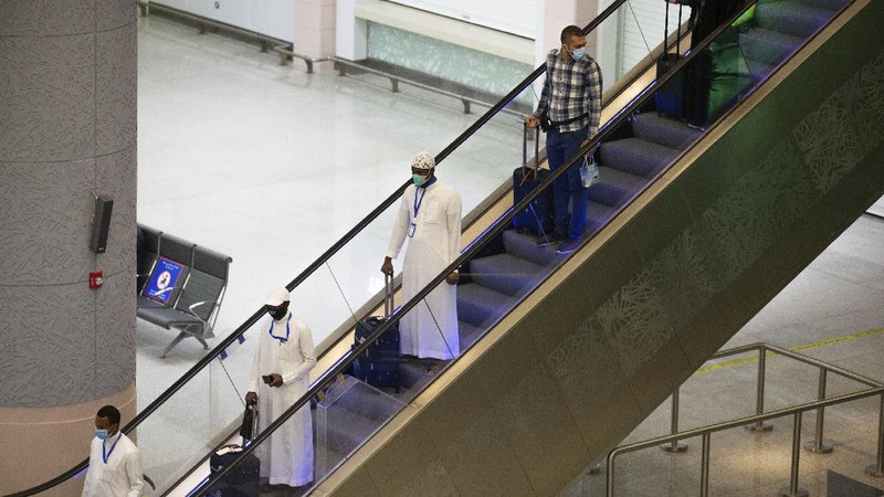 Pilgrims arrive to King Abdulaziz Airport for the Hajj pilgrimage to Mecca, in Jeddah, Saudi Arabia, Saturday, July 25, 2020. Saudi Arabia issued guidelines for about 1,000 pilgrims who will be allowed to perform the hajj pilgrimage in Mecca later this month (Saudi Ministry of Media via AP)