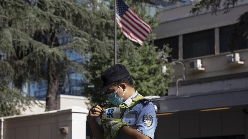 Workers prepare to cover up the areas where the signage used to show the location as United States Consulate in Chengdu in southwest China's Sichuan province on Monday, July 27, 2020. Chinese authorities took control of the former U.S. consulate in the southwestern Chinese city of Chengdu on Monday after it was ordered closed in retaliation for a U.S. order to vacate the Chinese Consulate in Houston. (AP Photo/Ng Han Guan)
