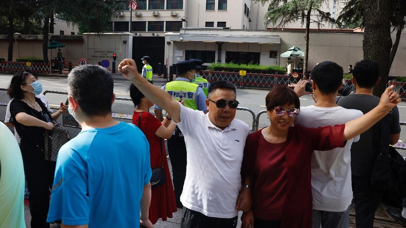 Workers prepare to cover up the areas where the signage used to show the location as United States Consulate in Chengdu in southwest China's Sichuan province on Monday, July 27, 2020. Chinese authorities took control of the former U.S. consulate in the southwestern Chinese city of Chengdu on Monday after it was ordered closed in retaliation for a U.S. order to vacate the Chinese Consulate in Houston. (AP Photo/Ng Han Guan)