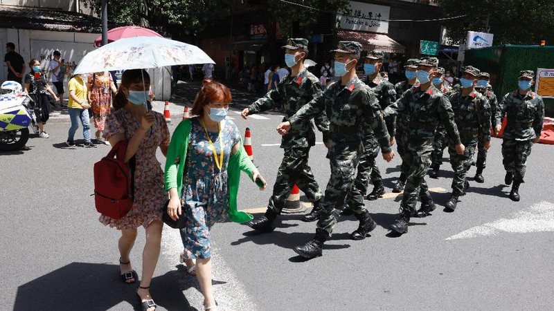 Workers prepare to cover up the areas where the signage used to show the location as United States Consulate in Chengdu in southwest China's Sichuan province on Monday, July 27, 2020. Chinese authorities took control of the former U.S. consulate in the southwestern Chinese city of Chengdu on Monday after it was ordered closed in retaliation for a U.S. order to vacate the Chinese Consulate in Houston. (AP Photo/Ng Han Guan)