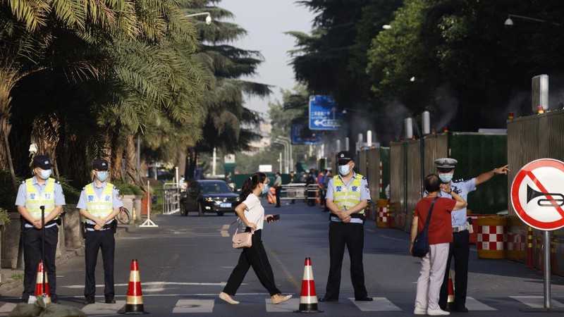 Workers prepare to cover up the areas where the signage used to show the location as United States Consulate in Chengdu in southwest China's Sichuan province on Monday, July 27, 2020. Chinese authorities took control of the former U.S. consulate in the southwestern Chinese city of Chengdu on Monday after it was ordered closed in retaliation for a U.S. order to vacate the Chinese Consulate in Houston. (AP Photo/Ng Han Guan)