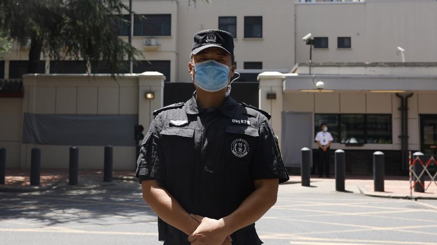 Workers prepare to cover up the areas where the signage used to show the location as United States Consulate in Chengdu in southwest China's Sichuan province on Monday, July 27, 2020. Chinese authorities took control of the former U.S. consulate in the southwestern Chinese city of Chengdu on Monday after it was ordered closed in retaliation for a U.S. order to vacate the Chinese Consulate in Houston. (AP Photo/Ng Han Guan)