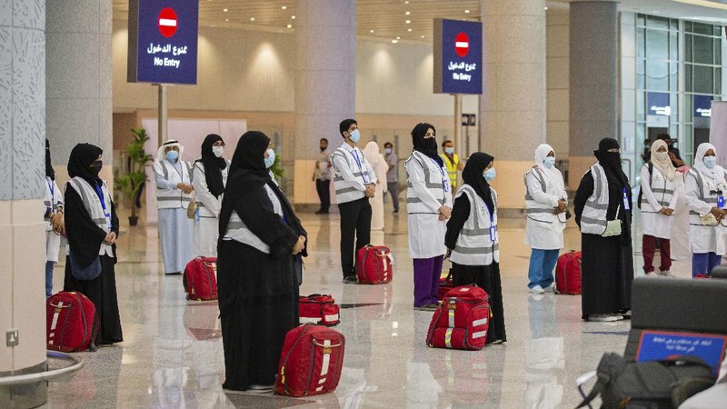 Pilgrims arrive to King Abdulaziz Airport for the Hajj pilgrimage to Mecca, in Jeddah, Saudi Arabia, Saturday, July 25, 2020. (Saudi Ministry of Media via AP)