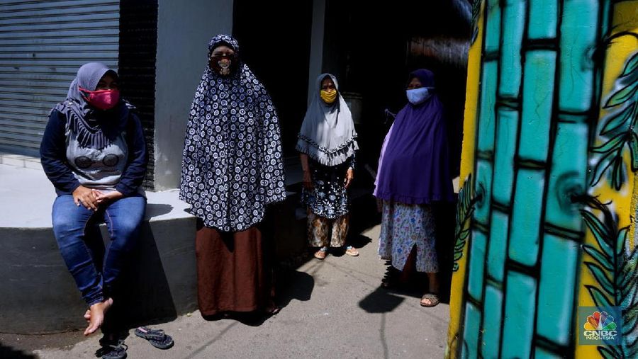 Warga mengenakan masker di Kawasan Kampung Rawa Pasung RW 022, Kelurahan Kota Baru, Kecamatan Bekasi Barat, Kota Bekasi, Jawa Barat, Selasa (28/7/2020).

Lokasi yang berbatasan dengan Jakarta Timur ini , kampung rawa pasung bekasi ini dikenal sebagai wilayah zona hijau sejak awal pandemi Maret lalu.

Beragam mural berisi pesan kepatuhan terhadap protokol kesehatan menghiasi gang sempit di kawasan hunian padat tersebut.

Warga sukarela memberikan paket sembako gratis bagi warga lain yang membutuhkan dan menyediakan ruang isolasi mandiri untuk yang terkena Covid-19.

Pak Soleh selaku ketua RW mengklaim bahwa kampung tersebut 0 positif Corona dan masuk zona hijau. 