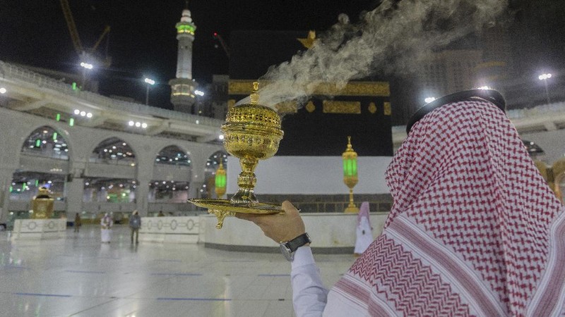 Workers disinfect the ground outside the Grand Mosque, over fears of the new coronavirus, at the Muslim holy city of Mecca, Saudi Arabia, Monday, July 27, 2020. Anywhere from 1,000 to 10,000 pilgrims will be allowed to perform the annual hajj pilgrimage this year due to the coronavirus pandemic. (AP Photo)