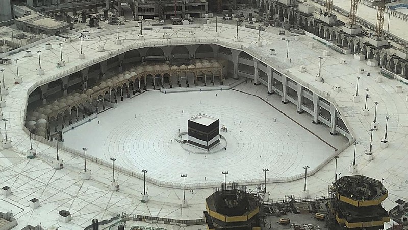 Workers disinfect the ground outside the Grand Mosque, over fears of the new coronavirus, at the Muslim holy city of Mecca, Saudi Arabia, Monday, July 27, 2020. Anywhere from 1,000 to 10,000 pilgrims will be allowed to perform the annual hajj pilgrimage this year due to the coronavirus pandemic. (AP Photo)