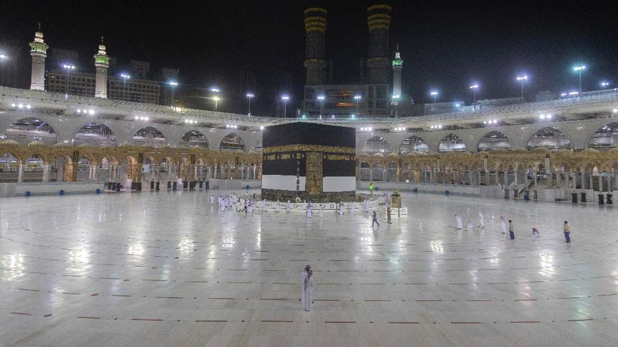 Workers disinfect the ground outside the Grand Mosque, over fears of the new coronavirus, at the Muslim holy city of Mecca, Saudi Arabia, Monday, July 27, 2020. Anywhere from 1,000 to 10,000 pilgrims will be allowed to perform the annual hajj pilgrimage this year due to the coronavirus pandemic. (AP Photo)