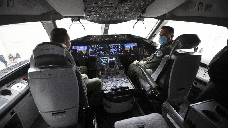A soldier stands guard inside the former Mexican presidential plane during a media tour following the daily, morning press conference of Mexican President Andres Manuel Lopez Obrador at Benito Juarez International Airport in Mexico City, Monday, July 27, 2020. The president, who only flies commercial as one measure in his austerity government, has been trying to sell the plane since he took office. (AP Photo/Marco Ugarte)