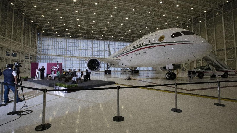 A soldier stands guard inside the former Mexican presidential plane during a media tour following the daily, morning press conference of Mexican President Andres Manuel Lopez Obrador at Benito Juarez International Airport in Mexico City, Monday, July 27, 2020. The president, who only flies commercial as one measure in his austerity government, has been trying to sell the plane since he took office. (AP Photo/Marco Ugarte)