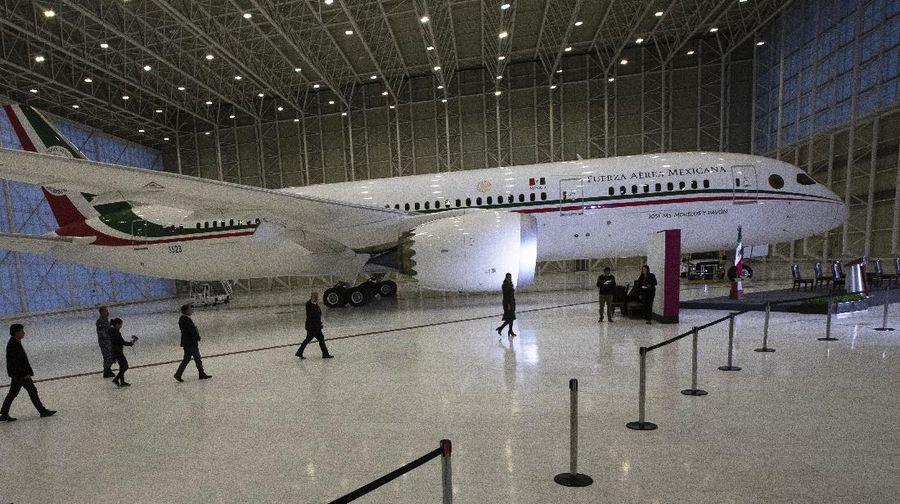 A soldier stands guard inside the former Mexican presidential plane during a media tour following the daily, morning press conference of Mexican President Andres Manuel Lopez Obrador at Benito Juarez International Airport in Mexico City, Monday, July 27, 2020. The president, who only flies commercial as one measure in his austerity government, has been trying to sell the plane since he took office. (AP Photo/Marco Ugarte)