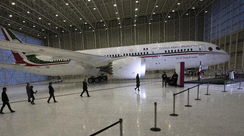 A soldier stands guard inside the former Mexican presidential plane during a media tour following the daily, morning press conference of Mexican President Andres Manuel Lopez Obrador at Benito Juarez International Airport in Mexico City, Monday, July 27, 2020. The president, who only flies commercial as one measure in his austerity government, has been trying to sell the plane since he took office. (AP Photo/Marco Ugarte)