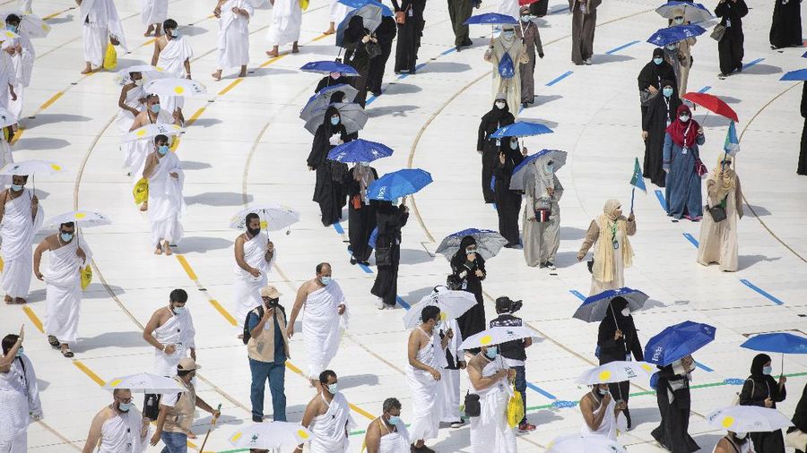 In this photo released by the Saudi Media Ministry, a limited numbers of pilgrims move several feet apart, circling the cube-shaped Kaaba in the first rituals of the hajj, as they keep social distancing to limit exposure and the potential transmission of the coronavirus, at the Grand Mosque in the Muslim holy city of Mecca, Saudi Arabia, Wednesday, July 29, 2020. The hajj, which started on Wednesday, is intended to bring about greater humility and unity among Muslims. (Saudi Media Ministry via AP)