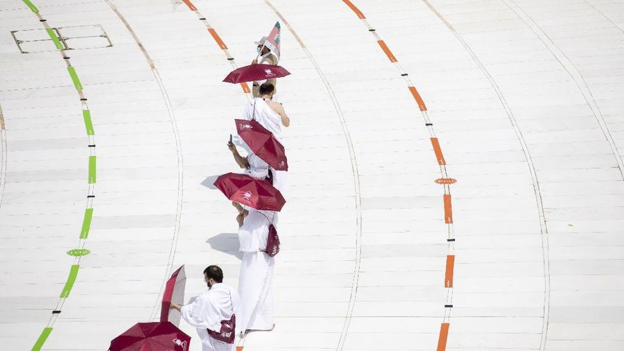 In this photo released by the Saudi Media Ministry, a limited numbers of pilgrims move several feet apart, circling the cube-shaped Kaaba in the first rituals of the hajj, as they keep social distancing to limit exposure and the potential transmission of the coronavirus, at the Grand Mosque in the Muslim holy city of Mecca, Saudi Arabia, Wednesday, July 29, 2020. The hajj, which started on Wednesday, is intended to bring about greater humility and unity among Muslims. (Saudi Media Ministry via AP)