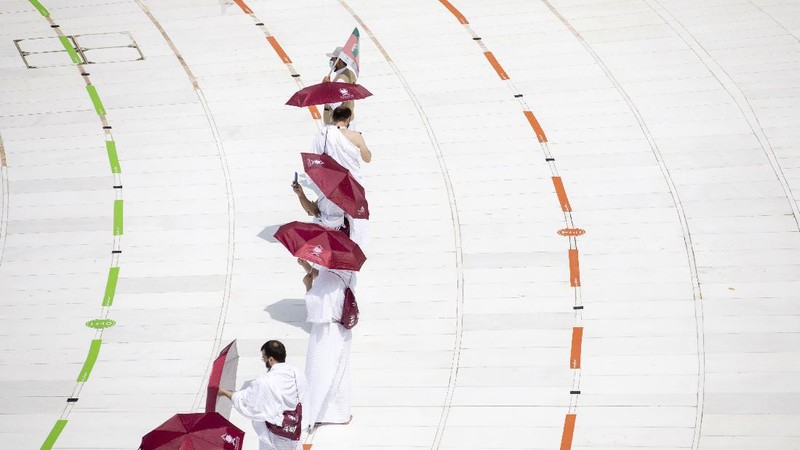 In this photo released by the Saudi Media Ministry, a limited numbers of pilgrims move several feet apart, circling the cube-shaped Kaaba in the first rituals of the hajj, as they keep social distancing to limit exposure and the potential transmission of the coronavirus, at the Grand Mosque in the Muslim holy city of Mecca, Saudi Arabia, Wednesday, July 29, 2020. The hajj, which started on Wednesday, is intended to bring about greater humility and unity among Muslims. (Saudi Media Ministry via AP)