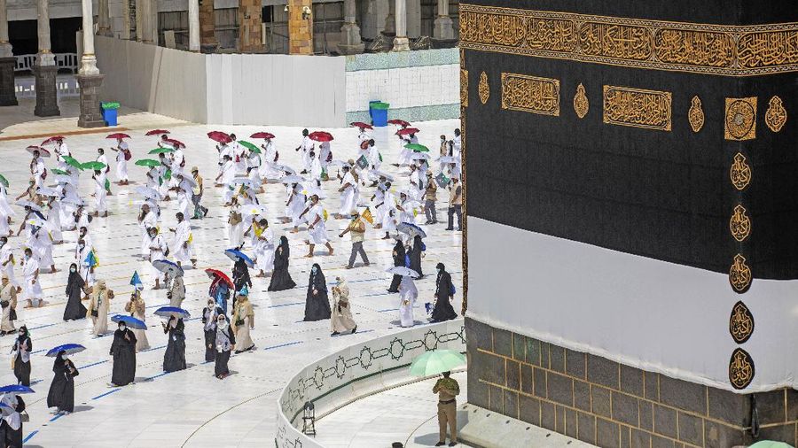 In this photo released by the Saudi Media Ministry, a limited numbers of pilgrims move several feet apart, circling the cube-shaped Kaaba in the first rituals of the hajj, as they keep social distancing to limit exposure and the potential transmission of the coronavirus, at the Grand Mosque in the Muslim holy city of Mecca, Saudi Arabia, Wednesday, July 29, 2020. The hajj, which started on Wednesday, is intended to bring about greater humility and unity among Muslims. (Saudi Media Ministry via AP)