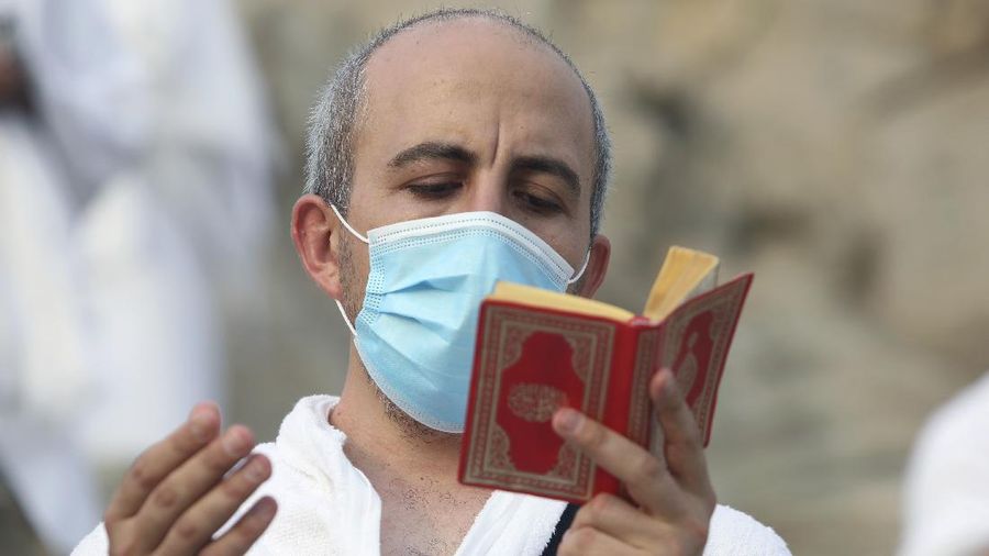 Muslim pilgrims pray near the Mercy mountain in Arafat as they distance themselves to protect against coronavirus during the annual hajj pilgrimage near the holy city of Mecca, Saudi Arabia, Thursday, July 30, 2020. This year's hajj was dramatically scaled down from 2.5 million pilgrims to as few as 1,000 due to the coronavirus pandemic. (AP Photo)