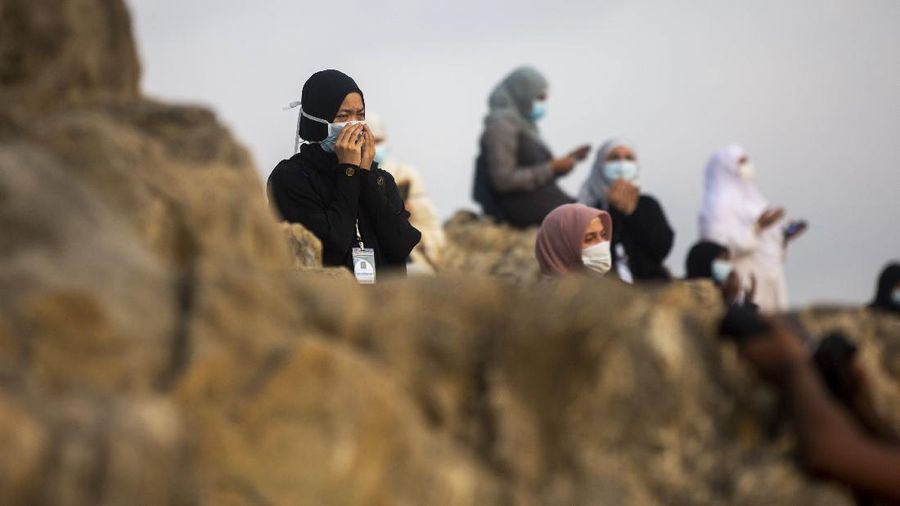 Muslim pilgrims pray near the Mercy mountain in Arafat as they distance themselves to protect against coronavirus during the annual hajj pilgrimage near the holy city of Mecca, Saudi Arabia, Thursday, July 30, 2020. This year's hajj was dramatically scaled down from 2.5 million pilgrims to as few as 1,000 due to the coronavirus pandemic. (AP Photo)