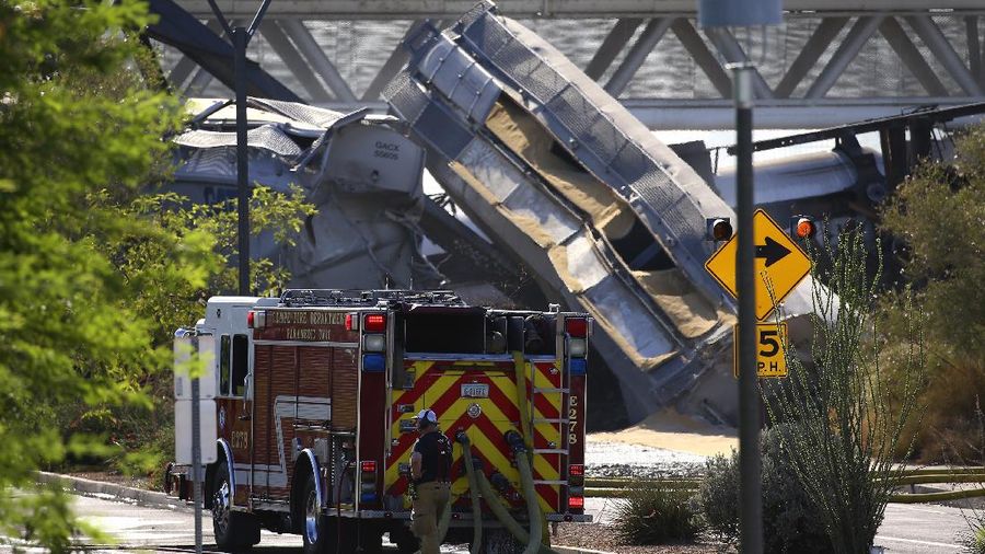 Smoke fills the sky at the scene of a train derailment in Tempe, Ariz., on Wednesday, July 29, 2020. Officials say a freight train traveling on a bridge that spans a lake in the Phoenix suburb derailed and set the bridge ablaze and partially collapsing the structure.  There were no immediate reports of any leaks. (Daniel Coronado via AP)