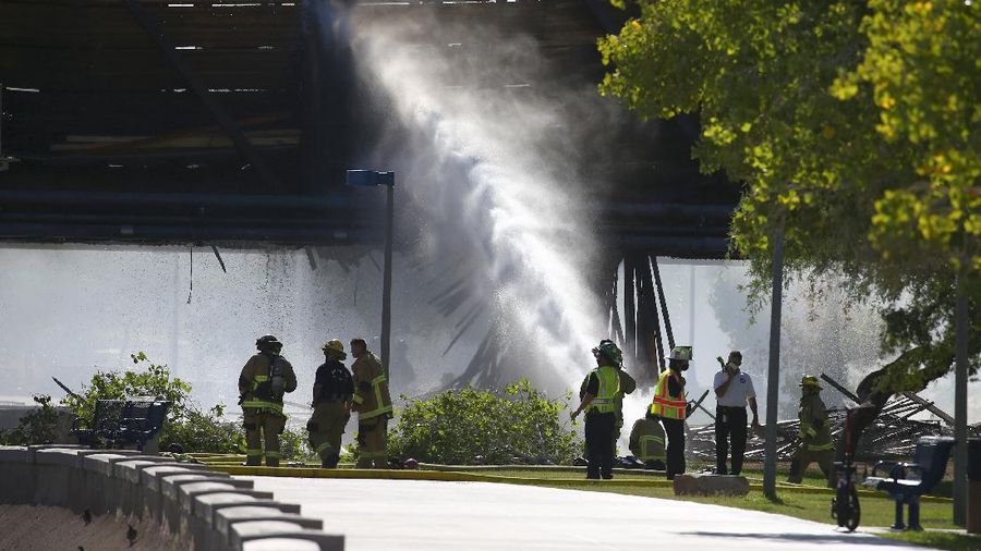 Smoke fills the sky at the scene of a train derailment in Tempe, Ariz., on Wednesday, July 29, 2020. Officials say a freight train traveling on a bridge that spans a lake in the Phoenix suburb derailed and set the bridge ablaze and partially collapsing the structure.  There were no immediate reports of any leaks. (Daniel Coronado via AP)