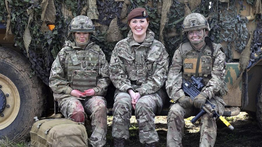 From left, Royal Army Medical Cops medic Corporal Vicky Helsby, 29, from Runcorn, Royal Wessex Yeomanry Tank Gunner reservist Lance Corporal Kat Dixon, 28, from Swindon and Royal Army Veterinary Corps Dog Handler Private Beth Johnson, 19, from Bridgwater during a Land Combat demonstration featuring women in command posts at Copehill Down Village on Salisbury Plain, Wiltshire. Women can now serve in all roles in Britain’s military, including front-line combat units and the special forces. Defense Secretary Gavin Williamson announced the change Thursday, saying 