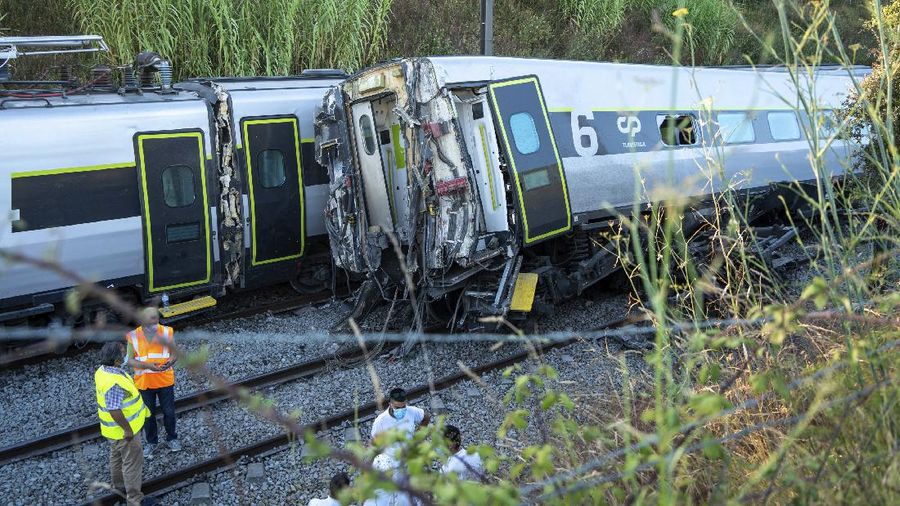 A broken window in a passenger car of an intercity train after it rammed into a maintenance vehicle on the track in Soure, northern Portugal, Friday, July 31, 2020. Two workers in the maintenance vehicle were killed and several passengers in the train were seriously injured. (AP Photo/Sergio Azenha)