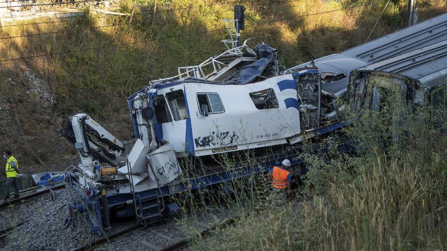 A broken window in a passenger car of an intercity train after it rammed into a maintenance vehicle on the track in Soure, northern Portugal, Friday, July 31, 2020. Two workers in the maintenance vehicle were killed and several passengers in the train were seriously injured. (AP Photo/Sergio Azenha)