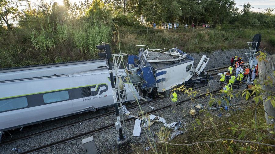 A broken window in a passenger car of an intercity train after it rammed into a maintenance vehicle on the track in Soure, northern Portugal, Friday, July 31, 2020. Two workers in the maintenance vehicle were killed and several passengers in the train were seriously injured. (AP Photo/Sergio Azenha)