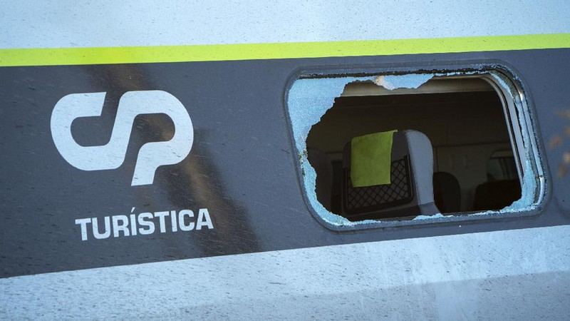 A broken window in a passenger car of an intercity train after it rammed into a maintenance vehicle on the track in Soure, northern Portugal, Friday, July 31, 2020. Two workers in the maintenance vehicle were killed and several passengers in the train were seriously injured. (AP Photo/Sergio Azenha)