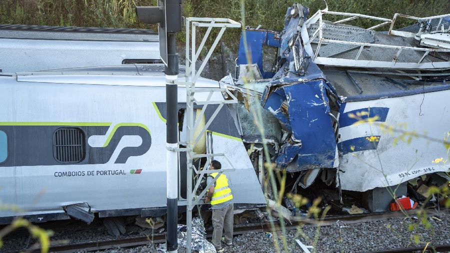 A broken window in a passenger car of an intercity train after it rammed into a maintenance vehicle on the track in Soure, northern Portugal, Friday, July 31, 2020. Two workers in the maintenance vehicle were killed and several passengers in the train were seriously injured. (AP Photo/Sergio Azenha)