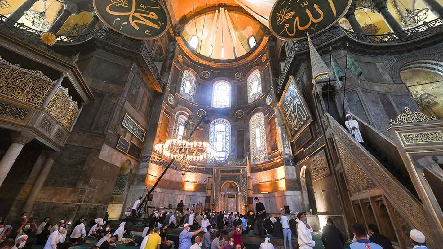 Muslims, wearing protective masks as a precaution against infection from coronavirus gather for the Eid al-Adha prayer inside the Byzantine-era Hagia Sophia, recently converted back to a mosque, in the historic Sultanahmet district of Istanbul, Friday, July 31, 2020. Small groups of pilgrims performed one of the final rites of the Islamic hajj on Friday as Muslims worldwide marked the start of the Eid al-Adha holiday amid a global pandemic that has impacted nearly every aspect of this year’s pilgrimage and celebrations. The last days of hajj coincide with the four-day Eid al-Adha, or “Feast of Sacrifice,” in which Muslims slaughter livestock and distribute the meat to the poor.  (Pool via AP)