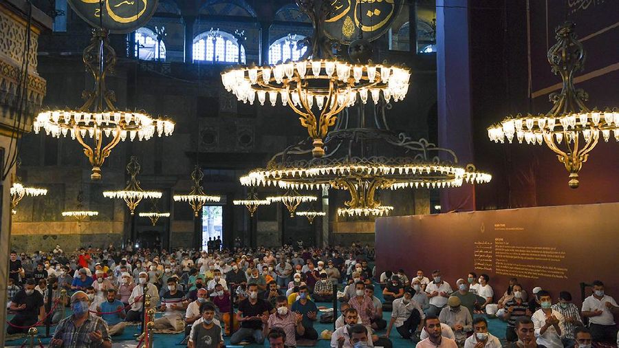 Muslims, wearing protective masks as a precaution against infection from coronavirus, gather for the Eid al-Adha prayer inside the Byzantine-era Hagia Sophia, recently converted back to a mosque, in the historic Sultanahmet district of Istanbul, Friday, July 31, 2020. Small groups of pilgrims performed one of the final rites of the Islamic hajj on Friday as Muslims worldwide marked the start of the Eid al-Adha holiday amid a global pandemic that has impacted nearly every aspect of this year’s pilgrimage and celebrations. The last days of hajj coincide with the four-day Eid al-Adha, or “Feast of Sacrifice,” in which Muslims slaughter livestock and distribute the meat to the poor.  (Pool via AP)