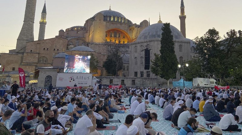 Muslims, wearing protective masks as a precaution against infection from coronavirus, gather for the Eid al-Adha prayer inside the Byzantine-era Hagia Sophia, recently converted back to a mosque, in the historic Sultanahmet district of Istanbul, Friday, July 31, 2020. Small groups of pilgrims performed one of the final rites of the Islamic hajj on Friday as Muslims worldwide marked the start of the Eid al-Adha holiday amid a global pandemic that has impacted nearly every aspect of this year’s pilgrimage and celebrations. The last days of hajj coincide with the four-day Eid al-Adha, or “Feast of Sacrifice,” in which Muslims slaughter livestock and distribute the meat to the poor.  (Pool via AP)