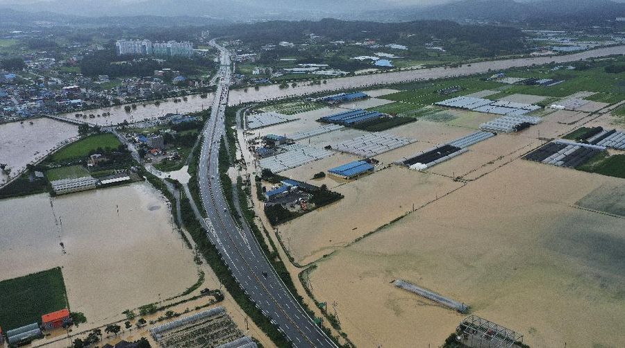 Rescue workers evacuate residents on a rubber boat to a safer place in Cheonan, South Korea, Monday, Aug. 3, 2020. Korean Meteorological Administration issued a warning of heavy rain for Seoul and central area. (Kim Jun-beom/Yonhap via AP)