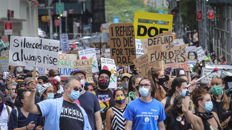 A coalition of teachers, students, and families protest during a rally called National Day of Resistance Against Unsafe School Reopening Opening, Monday, Aug. 3, 2020, in New York. Organizers said New York Governor Andrew Cuomo, New York Mayor Bill DeBlasio, Chancellor Richard Carranza, and the Department of Education must stop the in-person reopening of schools until it is safe for all. (AP Photo/Bebeto Matthews)