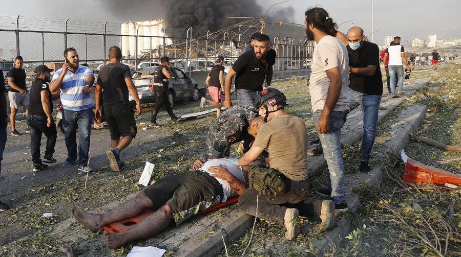 Fire burns after a massive explosion in Beirut, Lebanon, Tuesday, Aug. 4, 2020. Massive explosions rocked downtown Beirut on Tuesday, flattening much of the port, damaging buildings and blowing out windows and doors as a giant mushroom cloud rose above the capital. Witnesses saw many people injured by flying glass and debris. (AP Photo/Hassan Ammar)