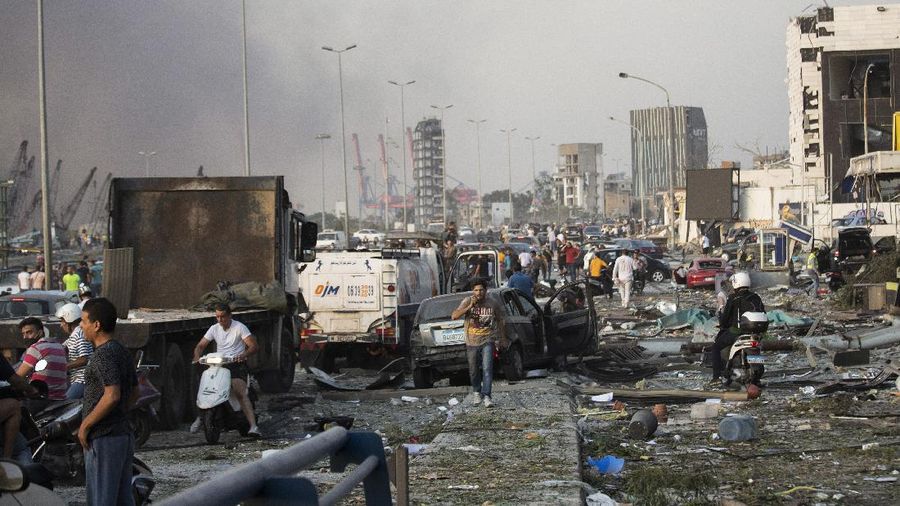 Fire burns after a massive explosion in Beirut, Lebanon, Tuesday, Aug. 4, 2020. Massive explosions rocked downtown Beirut on Tuesday, flattening much of the port, damaging buildings and blowing out windows and doors as a giant mushroom cloud rose above the capital. Witnesses saw many people injured by flying glass and debris. (AP Photo/Hassan Ammar)