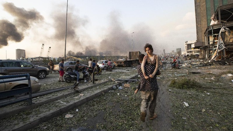 Fire burns after a massive explosion in Beirut, Lebanon, Tuesday, Aug. 4, 2020. Massive explosions rocked downtown Beirut on Tuesday, flattening much of the port, damaging buildings and blowing out windows and doors as a giant mushroom cloud rose above the capital. Witnesses saw many people injured by flying glass and debris. (AP Photo/Hassan Ammar)
