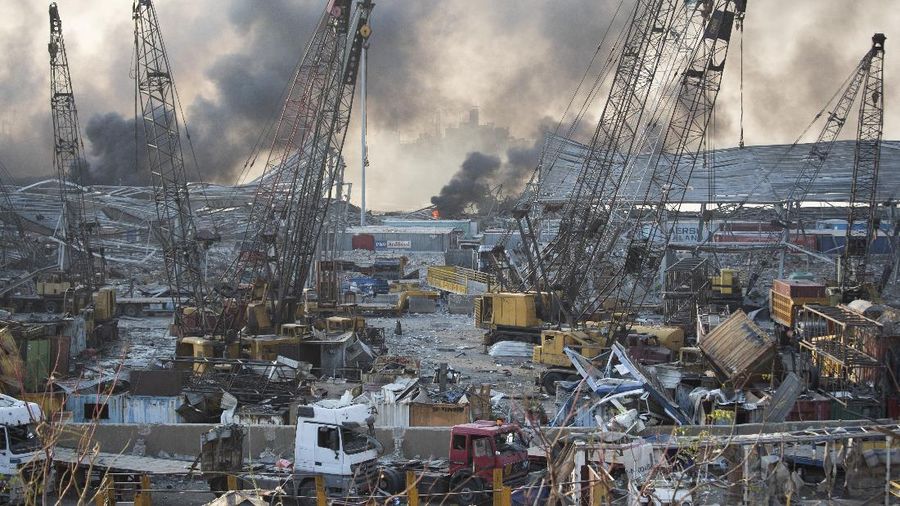 Fire burns after a massive explosion in Beirut, Lebanon, Tuesday, Aug. 4, 2020. Massive explosions rocked downtown Beirut on Tuesday, flattening much of the port, damaging buildings and blowing out windows and doors as a giant mushroom cloud rose above the capital. Witnesses saw many people injured by flying glass and debris. (AP Photo/Hassan Ammar)