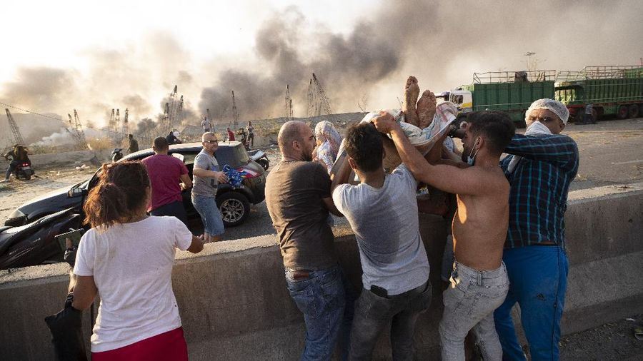 Fire burns after a massive explosion in Beirut, Lebanon, Tuesday, Aug. 4, 2020. Massive explosions rocked downtown Beirut on Tuesday, flattening much of the port, damaging buildings and blowing out windows and doors as a giant mushroom cloud rose above the capital. Witnesses saw many people injured by flying glass and debris. (AP Photo/Hassan Ammar)