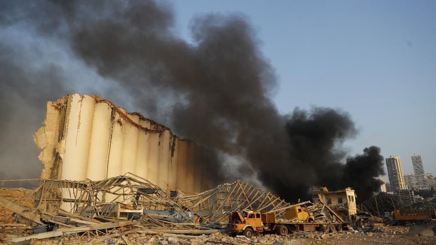 Fire burns after a massive explosion in Beirut, Lebanon, Tuesday, Aug. 4, 2020. Massive explosions rocked downtown Beirut on Tuesday, flattening much of the port, damaging buildings and blowing out windows and doors as a giant mushroom cloud rose above the capital. Witnesses saw many people injured by flying glass and debris. (AP Photo/Hassan Ammar)