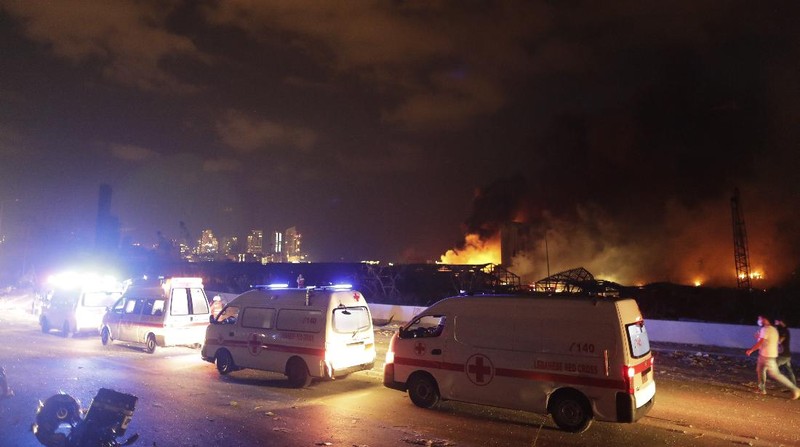 Fire burns after a massive explosion in Beirut, Lebanon, Tuesday, Aug. 4, 2020. Massive explosions rocked downtown Beirut on Tuesday, flattening much of the port, damaging buildings and blowing out windows and doors as a giant mushroom cloud rose above the capital. Witnesses saw many people injured by flying glass and debris. (AP Photo/Hassan Ammar)