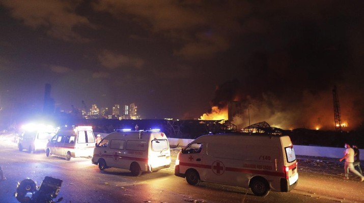 Ambulances drive past the site of a massive explosion in Beirut, Lebanon, Tuesday, Aug. 4, 2020. (AP Photo/Hassan Ammar)